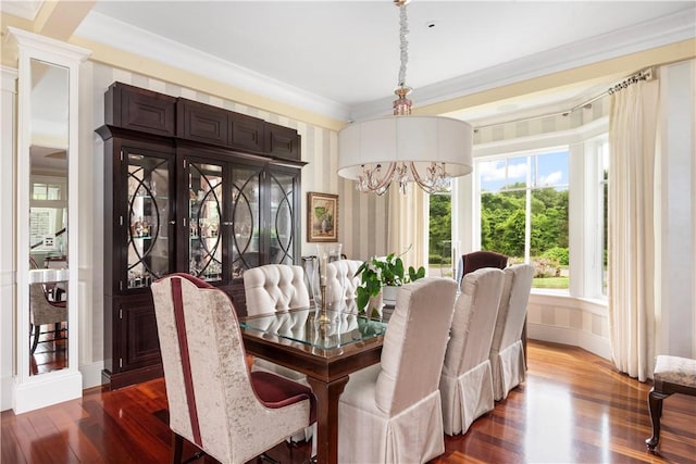 dining space featuring ornamental molding, dark wood-type flooring, baseboards, and a chandelier