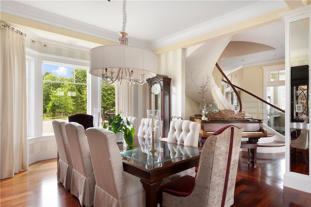 dining room with an inviting chandelier, hardwood / wood-style flooring, and ornamental molding