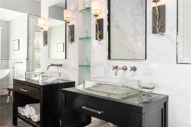 bathroom featuring a sink and tile walls