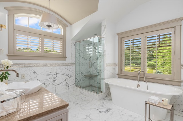 bathroom with tile walls, vaulted ceiling, and tile patterned flooring