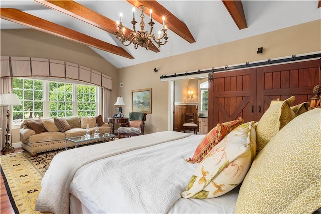 bedroom with ensuite bathroom, wood finished floors, a barn door, vaulted ceiling with beams, and an inviting chandelier