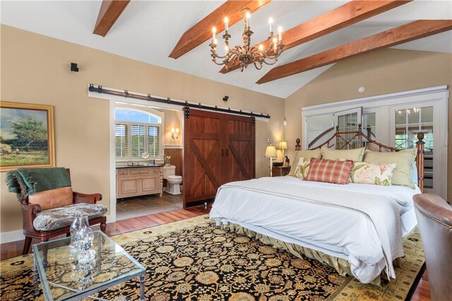 bedroom with connected bathroom, hardwood / wood-style flooring, vaulted ceiling with beams, a chandelier, and a barn door