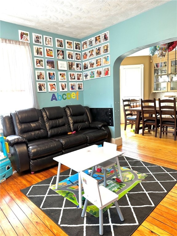 living room featuring hardwood / wood-style flooring and a textured ceiling