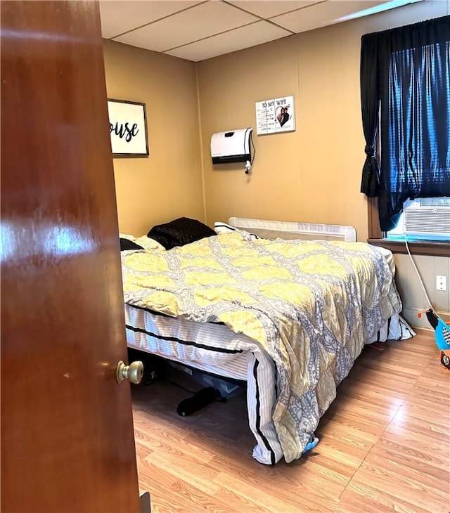 bedroom featuring light hardwood / wood-style floors and cooling unit