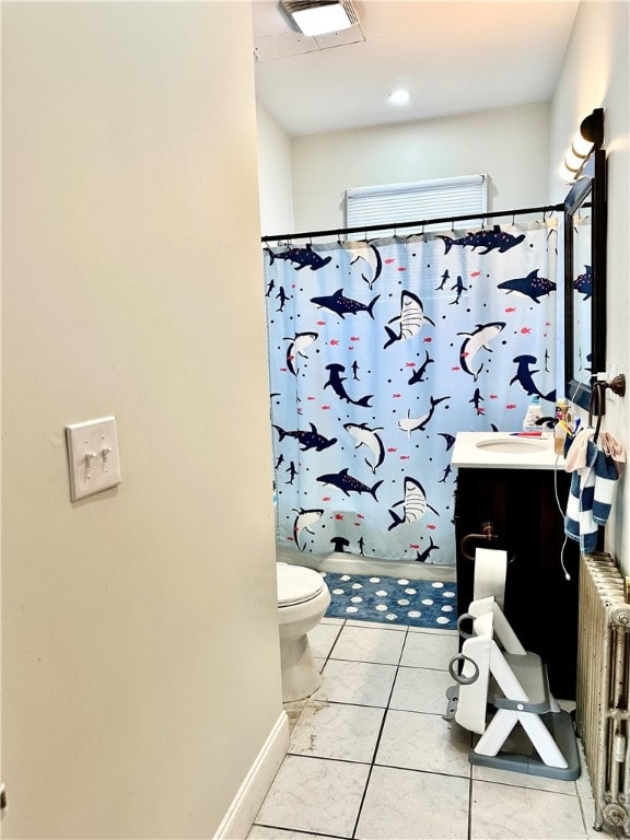 bathroom featuring vanity, radiator, tile patterned flooring, and toilet