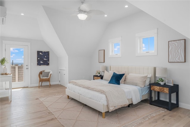 bedroom featuring light wood-type flooring, multiple windows, ceiling fan, and access to exterior