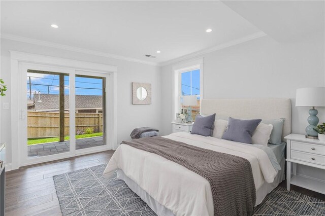 bedroom featuring crown molding, dark wood-type flooring, and access to outside