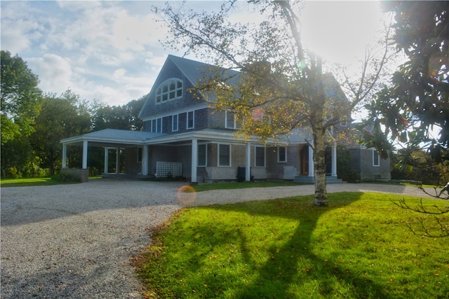 view of front of property featuring a carport and a front lawn