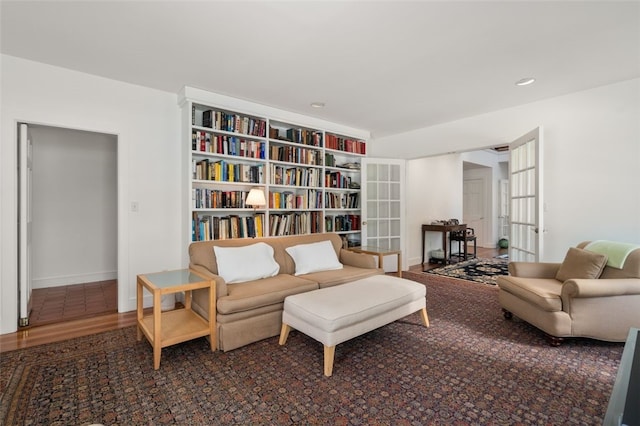 living area with french doors and wood-type flooring