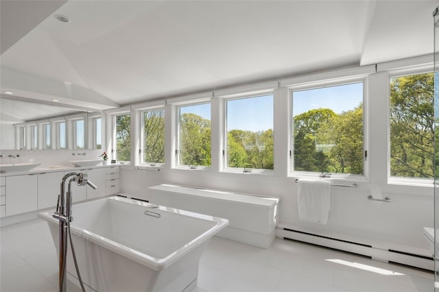 interior space with a baseboard heating unit, vaulted ceiling, and plenty of natural light