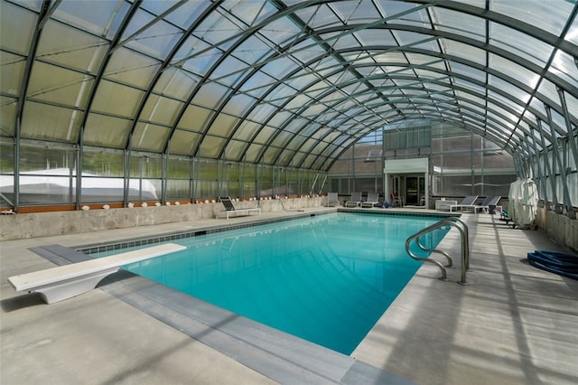 view of pool featuring a diving board