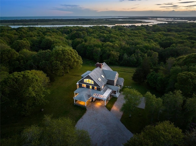 aerial view at dusk with a water view