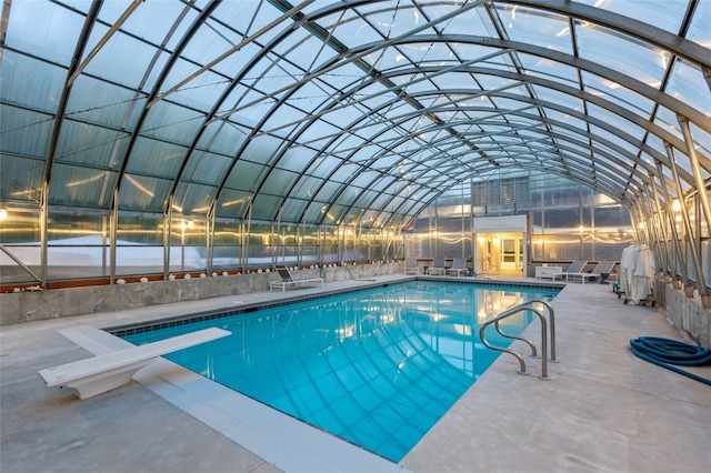 view of pool featuring a diving board