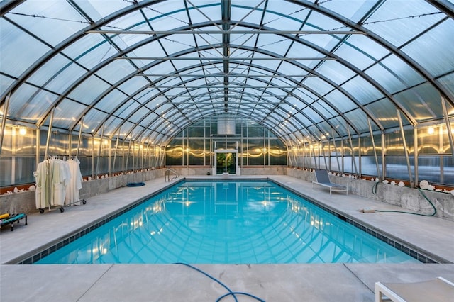 view of pool with glass enclosure