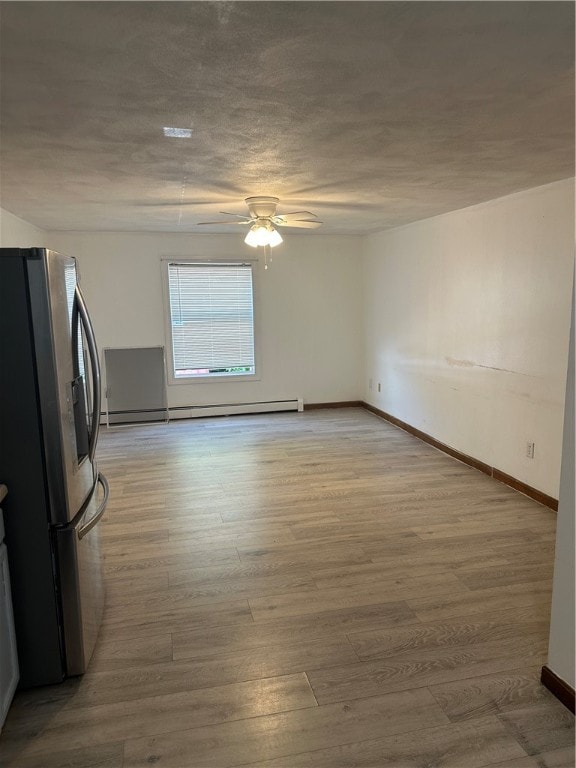 kitchen with ceiling fan, wood-type flooring, stainless steel fridge, and baseboard heating