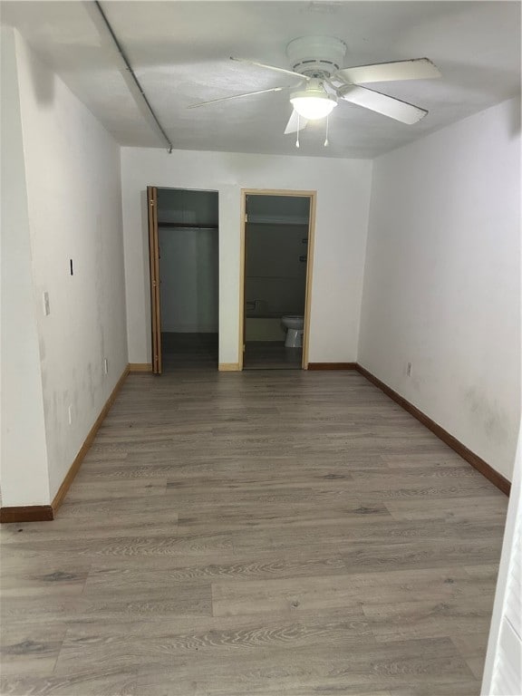 unfurnished bedroom with ceiling fan and hardwood / wood-style floors