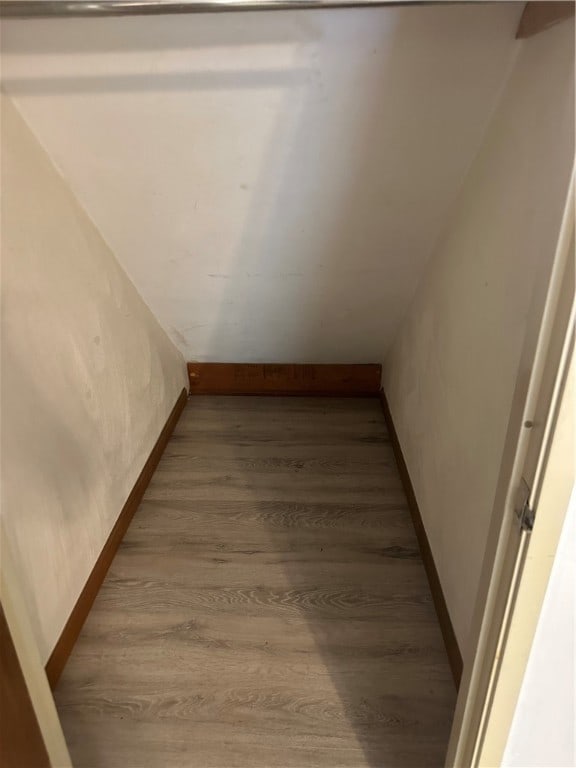 stairs featuring hardwood / wood-style floors