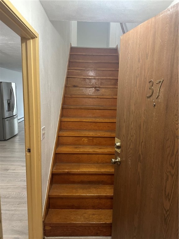 stairs with hardwood / wood-style floors