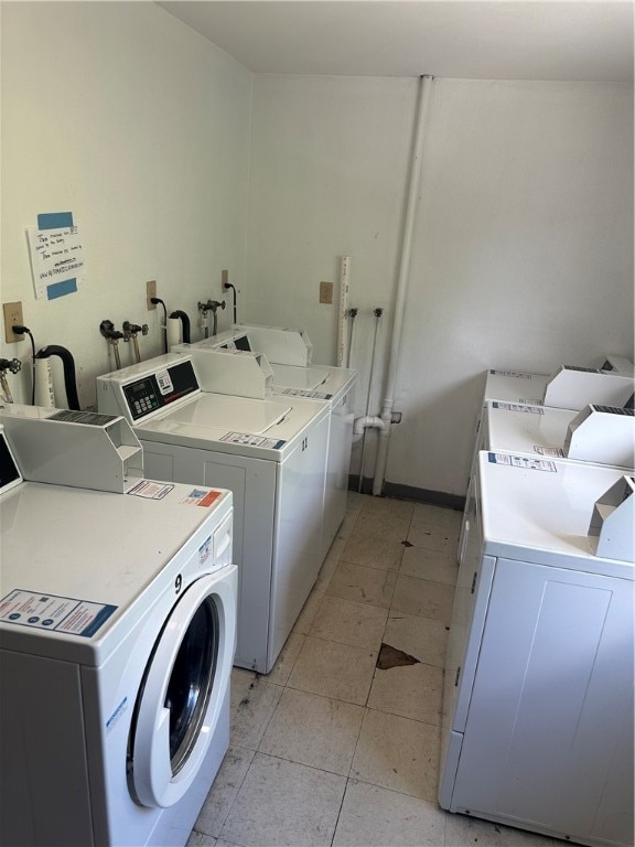 laundry room with light tile patterned floors and independent washer and dryer