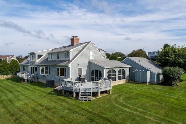 rear view of property with a wooden deck, a yard, and cooling unit