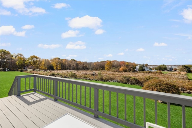 wooden terrace featuring a lawn