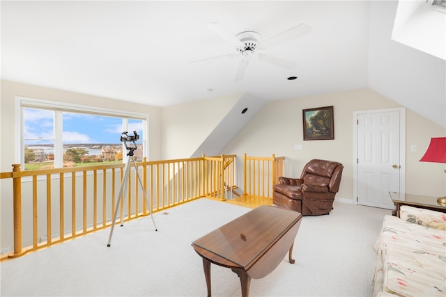 living room with vaulted ceiling, ceiling fan, and carpet flooring