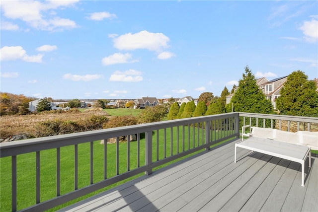 wooden deck with a lawn