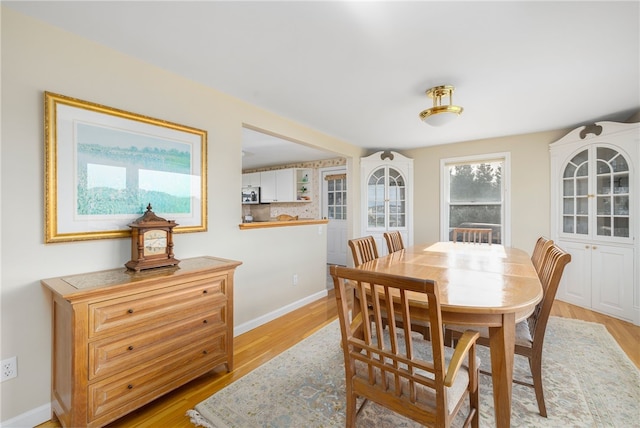 dining space with light wood-type flooring