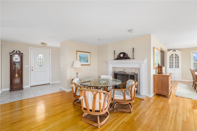 dining room featuring a fireplace and light hardwood / wood-style floors