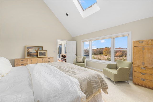 bedroom featuring high vaulted ceiling, a skylight, and light colored carpet