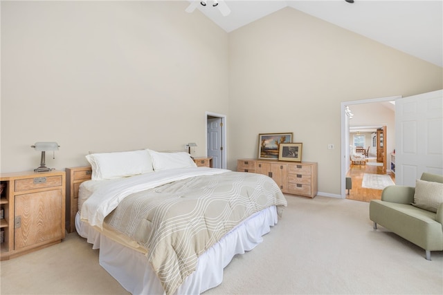 bedroom with high vaulted ceiling and light colored carpet