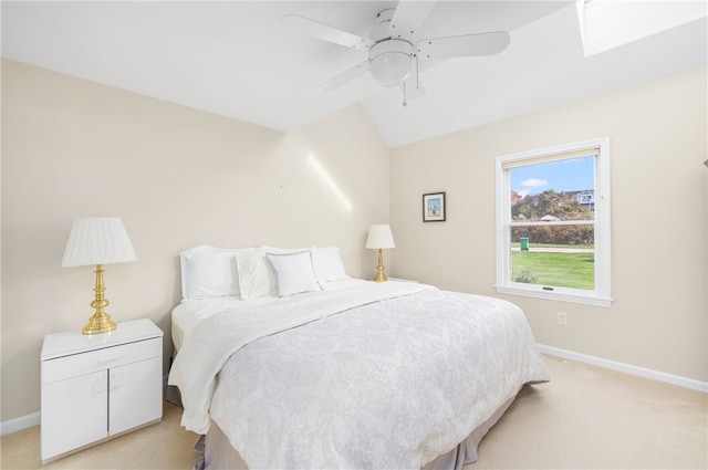 bedroom featuring vaulted ceiling, light colored carpet, and ceiling fan