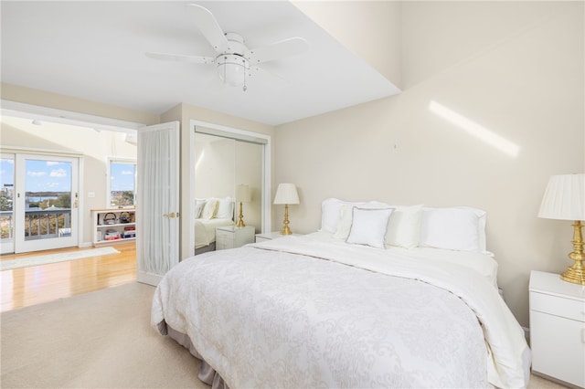 bedroom featuring access to outside, light hardwood / wood-style flooring, and ceiling fan