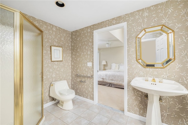 bathroom with toilet, an enclosed shower, and tile patterned floors