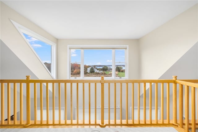 hall with light colored carpet