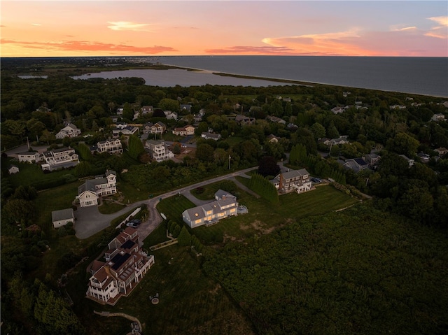 aerial view at dusk with a water view