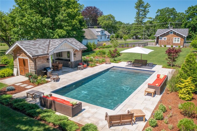 view of swimming pool with an outdoor hangout area, an outdoor structure, a patio area, and a yard