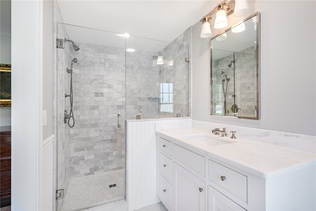 bathroom with vanity and a shower with shower door