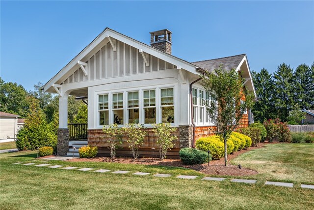 view of front of home with a front lawn and a porch