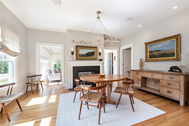 dining room featuring light wood-type flooring and a chandelier