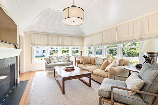 living room featuring light hardwood / wood-style flooring and high vaulted ceiling