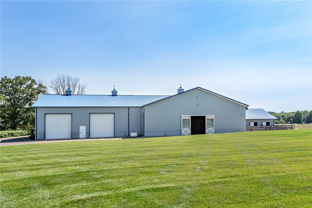 view of front of home with a front yard and a garage