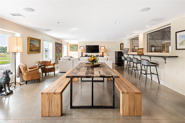 dining room featuring ornamental molding and a wealth of natural light