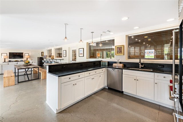 kitchen with dishwasher, sink, white cabinets, hanging light fixtures, and concrete floors