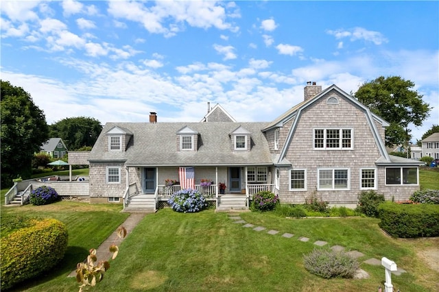 view of front of house with a front yard and covered porch