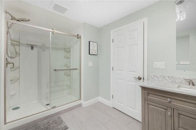 bathroom featuring tile patterned floors, vanity, and an enclosed shower