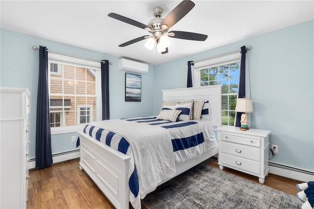 bedroom featuring a wall mounted AC, multiple windows, ceiling fan, and a baseboard heating unit