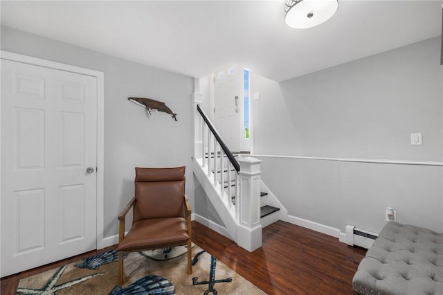 sitting room with dark hardwood / wood-style floors and baseboard heating