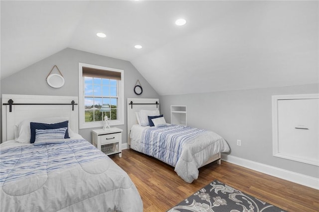 bedroom featuring dark hardwood / wood-style flooring and vaulted ceiling