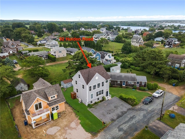 birds eye view of property with a water view